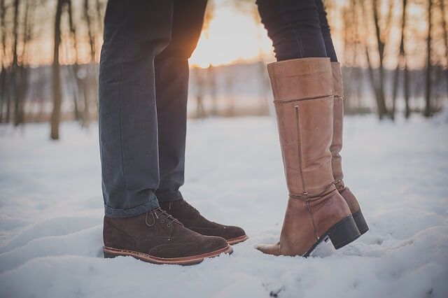 a couple standing in the snow have relationship issues.