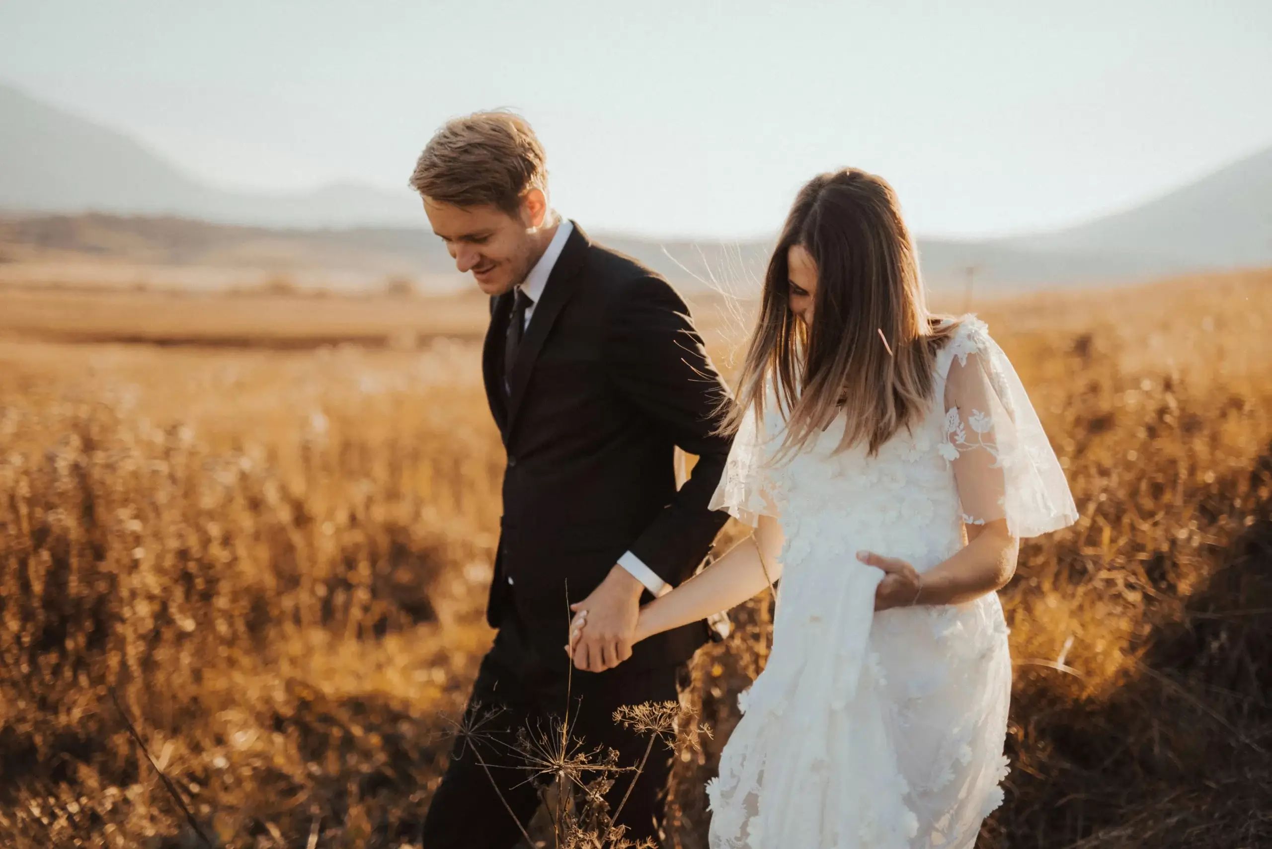 New bride and groom who are walking through a field | counseling