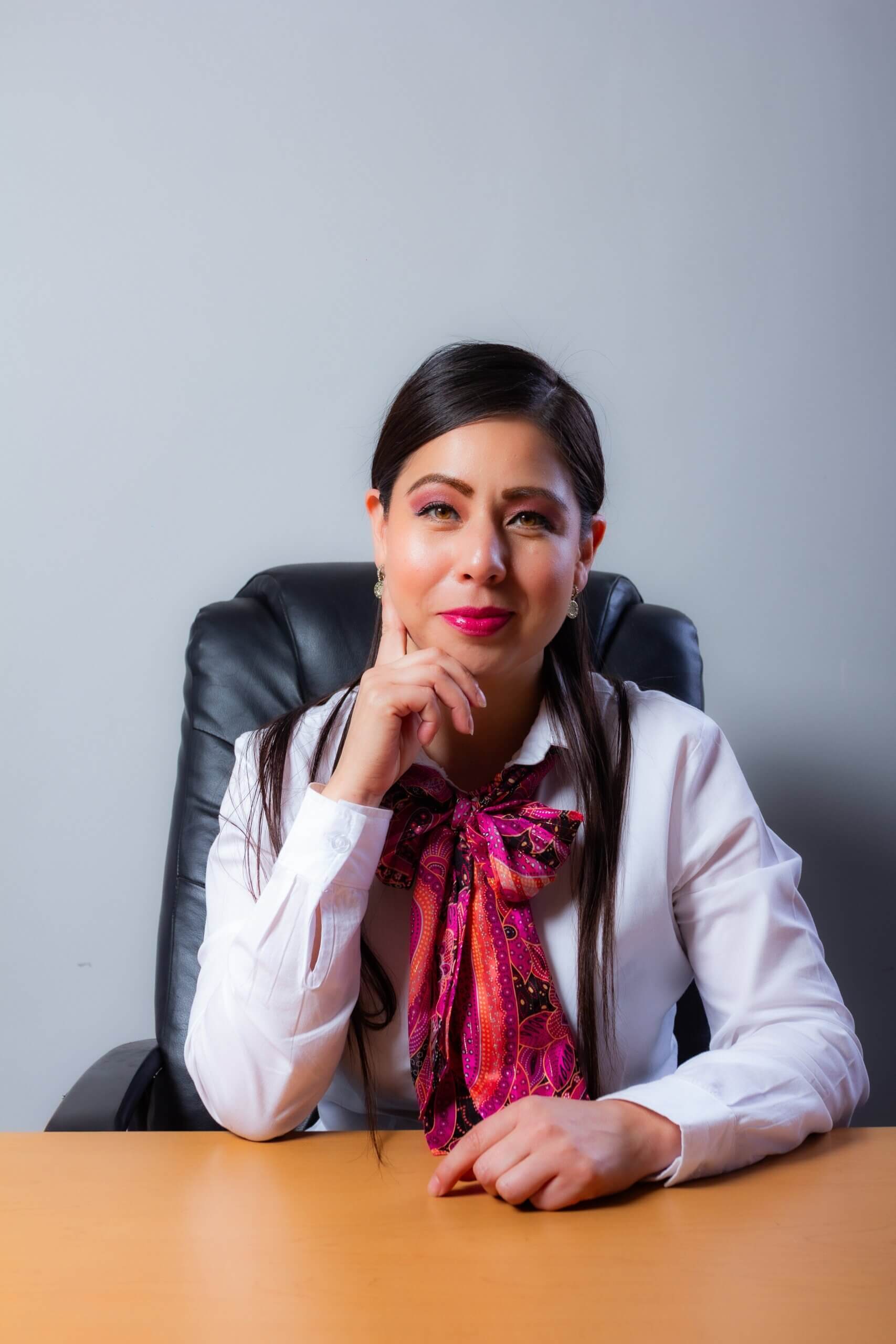 Woman in glasses sitting at her desk contemplating professional counseling