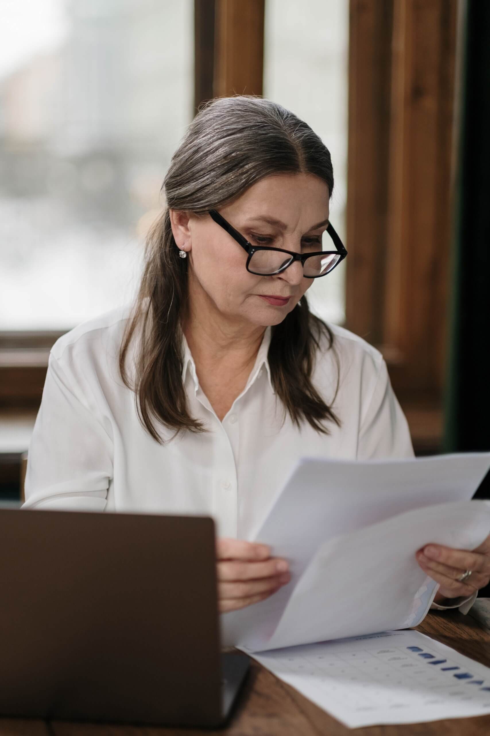 woman sitting at her desk considering counseling for executives