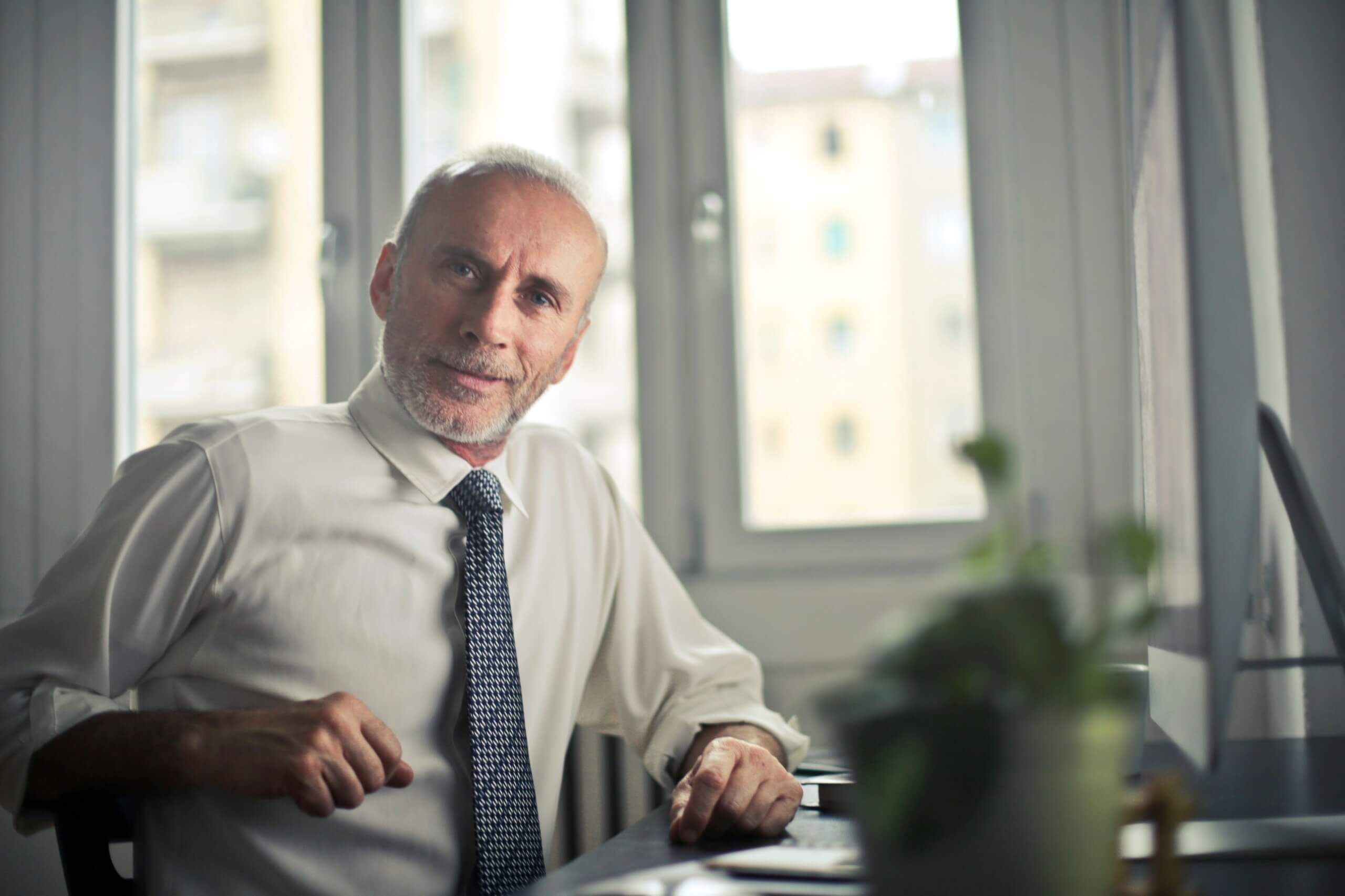 Man sitting at his desk looking at the camera